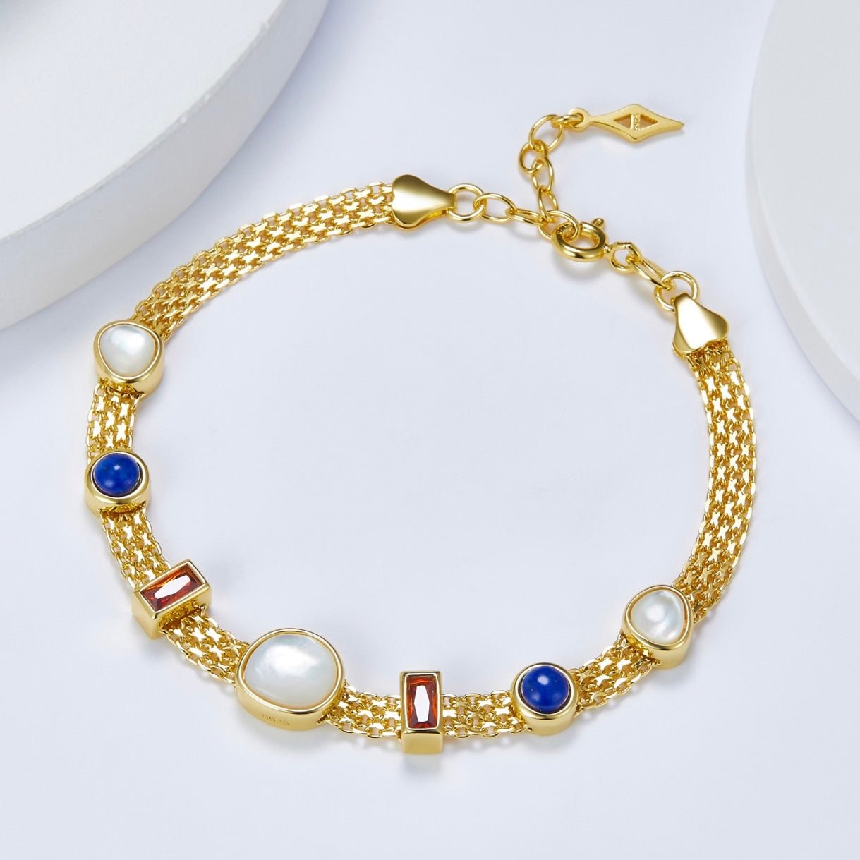 Lumière Strand Bracelet by Awakened Time crafted in 925 sterling silver with 18ct gold vermeil finish and natural garnet, lapis lazuli, and mother-of-pearl gemstone accents.