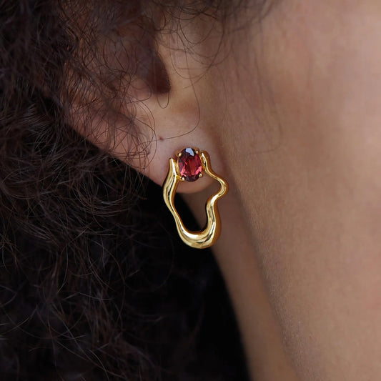 Awakened Time Rouge Wave earrings modeled featuring rich garnet gemstones set in gold vermeil