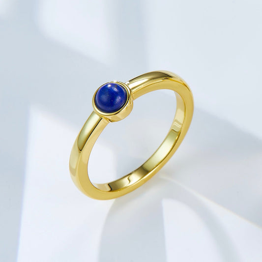 Luna Nova Ring featuring a natural blue lapis lazuli cabochon set in 18ct recycled gold vermeil against a clean background
