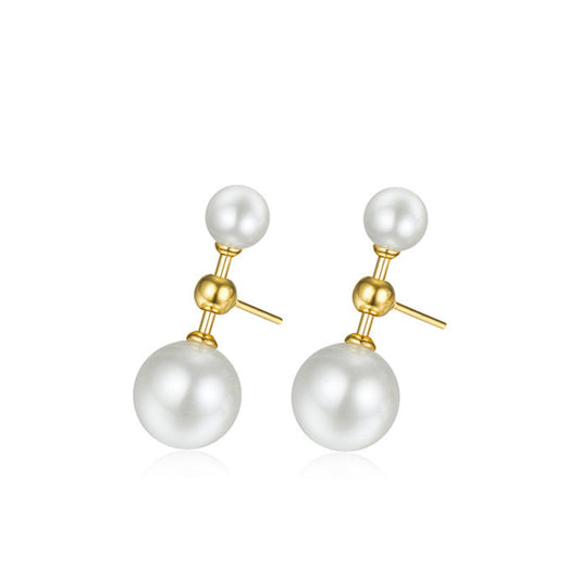Pair of Awakened Time L’Équilibre double pearl earrings featuring a small top white pearl and a larger bottom white pearl connected by a gold vertical bar on a white background.