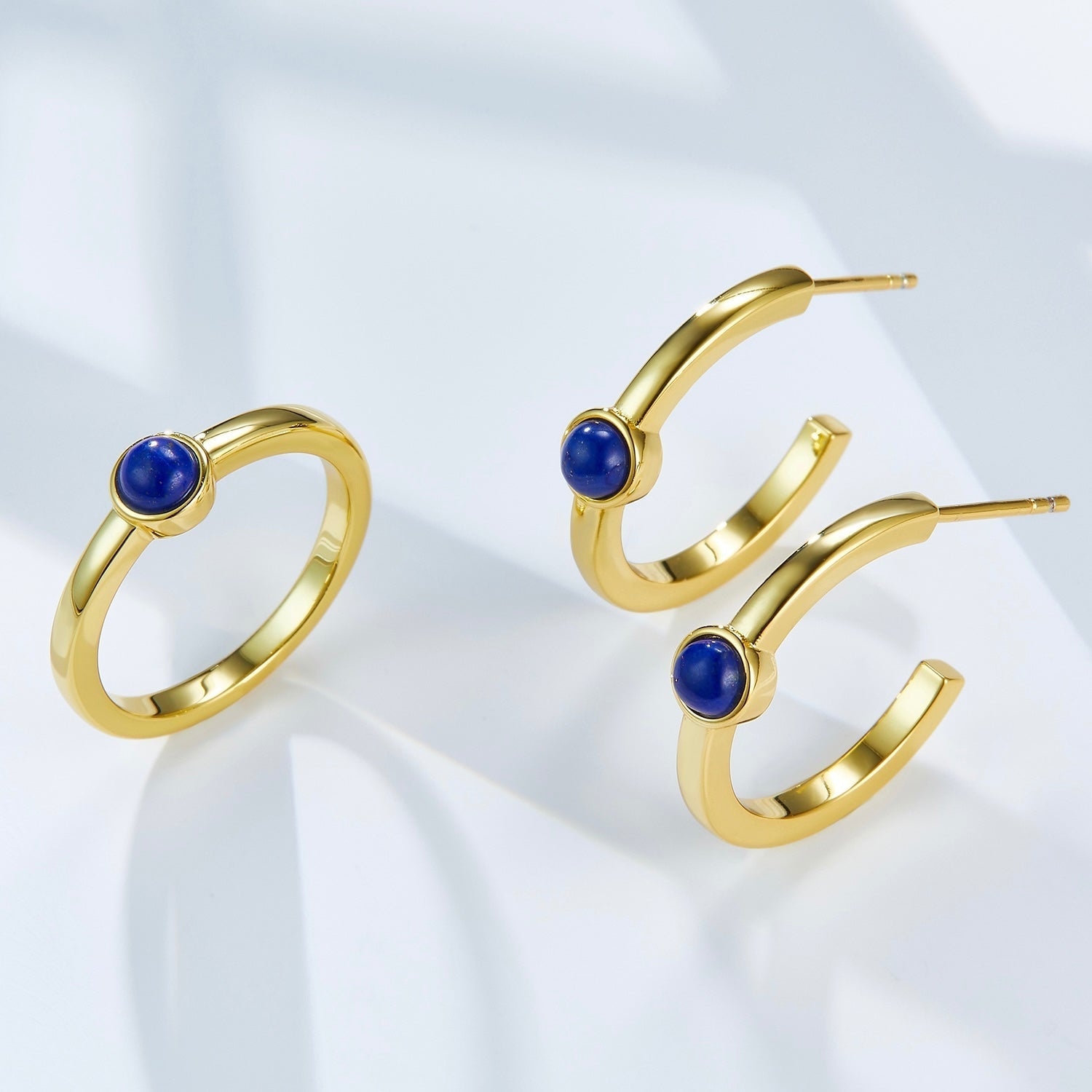 Matching 18ct gold vermeil lapis lazuli jewelry set featuring a solitaire ring and hoop earrings, handcrafted by Awakened Time for modern luxury styling.