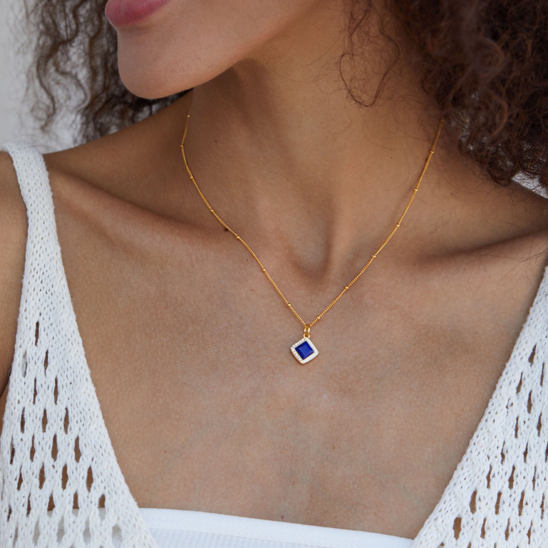 Front view of a model wearing the square lapis lazuli Bleu Intuition necklace by Awakened Time.
