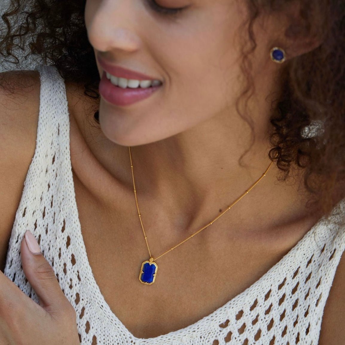 Model wearing the Awakened Time Bleu Nuit gold vermeil necklace featuring an elongated octagonal lapis lazuli pendant.