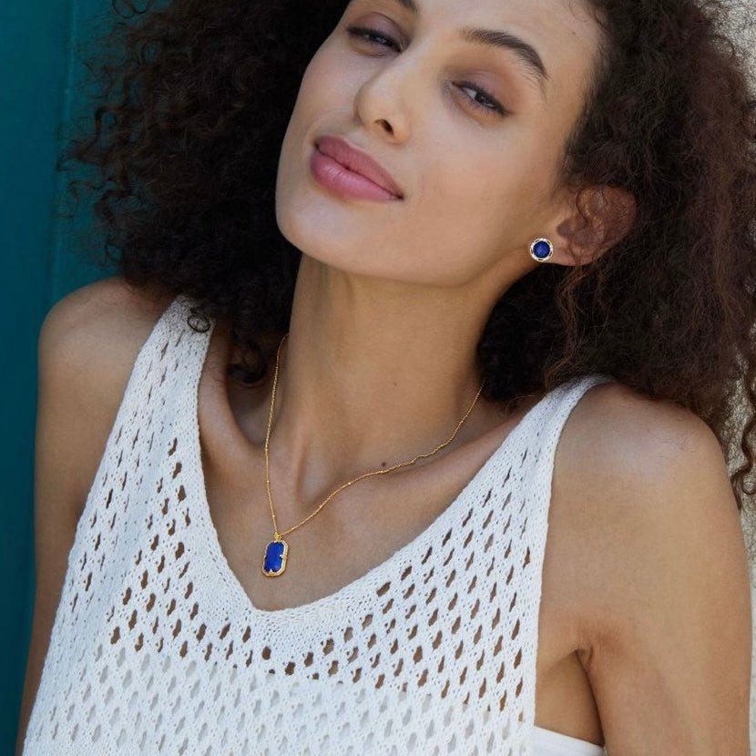 Model wearing the Awakened Time Bleu Nuit lapis lazuli necklace paired with lapis earrings seem enjoying with her lover.