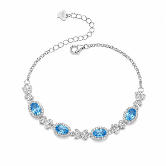 Awakened Time Bluelace Bracelet in S925 sterling silver with four natural blue topaz gemstones and butterfly-inspired details.