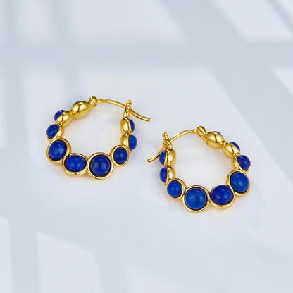 Pair of Awakened Time Céleste 18ct gold vermeil hoop earrings with deep blue lapis lazuli gemstones.