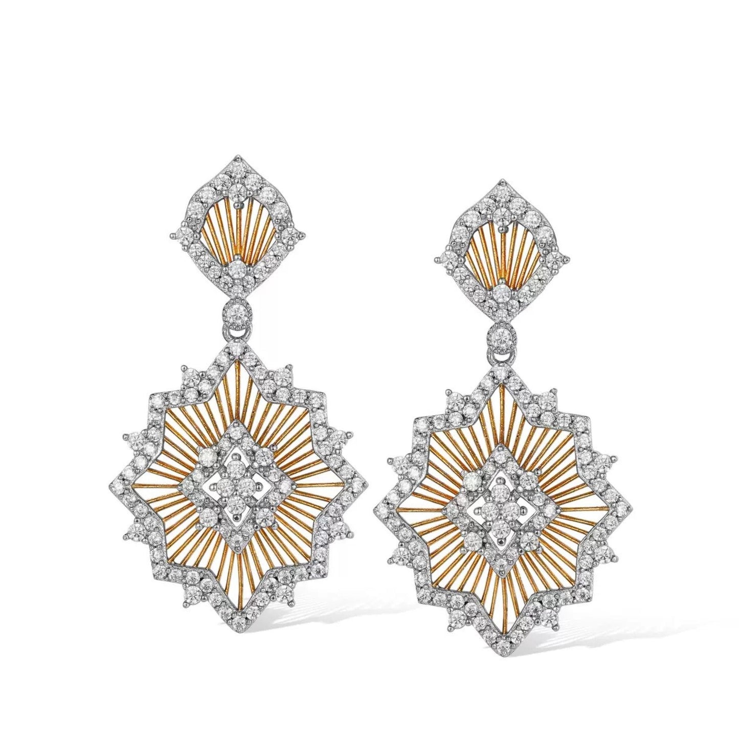 Pair of Awakened Time Éclat de Soleil two-tone drop earrings featuring openwork gold sunburst rays framed by pavé cubic zirconia pavé borders on a white background.