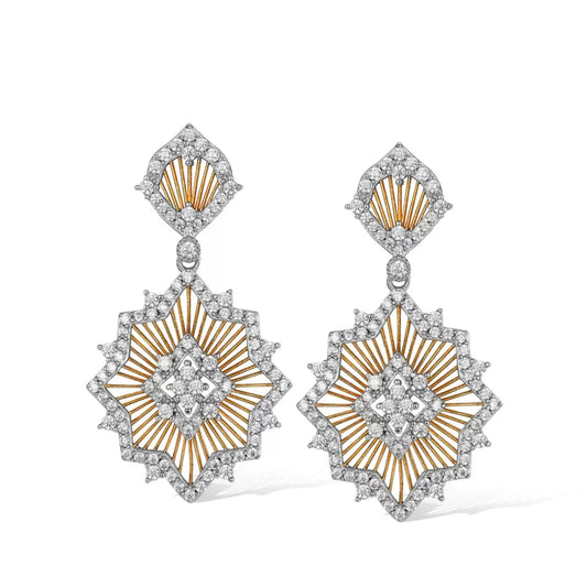 Pair of Awakened Time Éclat de Soleil two-tone drop earrings featuring openwork gold sunburst rays framed by pavé cubic zirconia pavé borders on a white background.