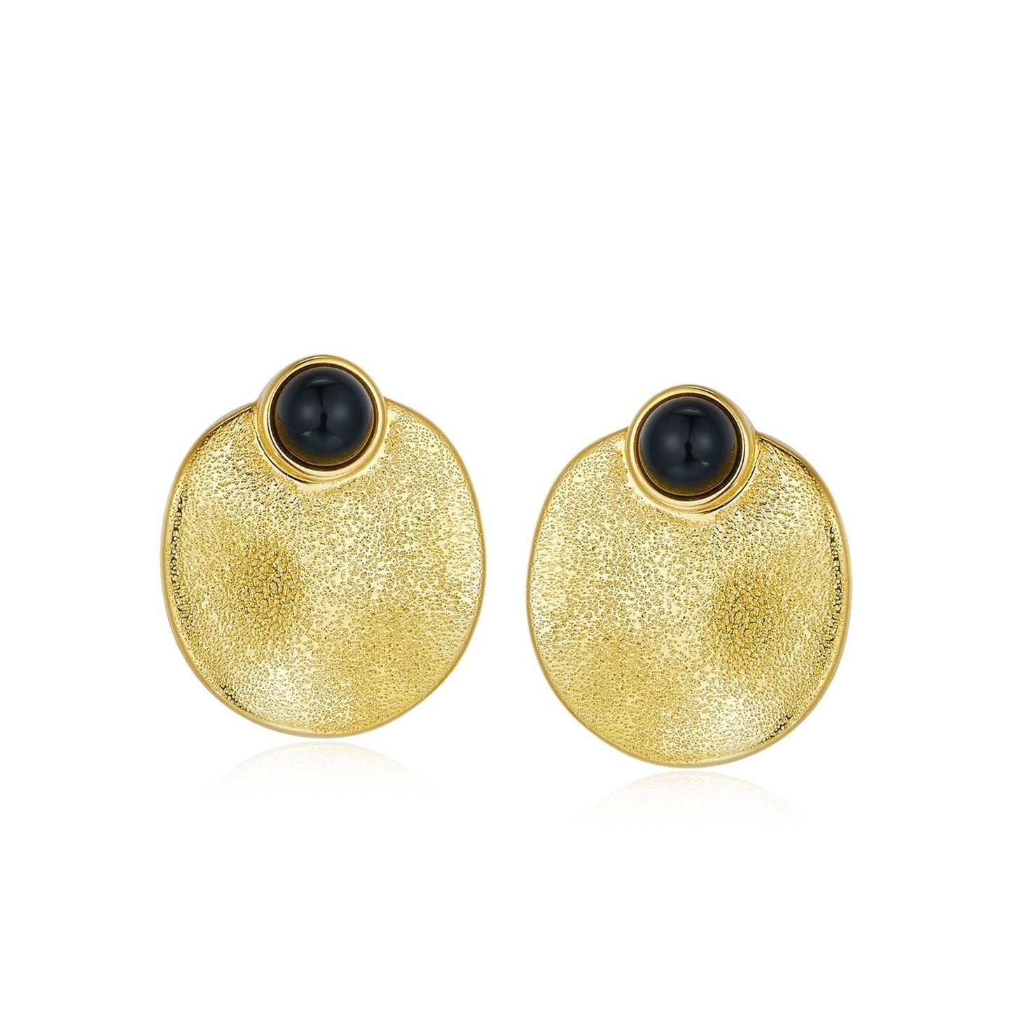 Pair of Awakened Time Eclipse stud earrings featuring polished round black onyx cabochons set atop textured dished gold circular discs on a white background.