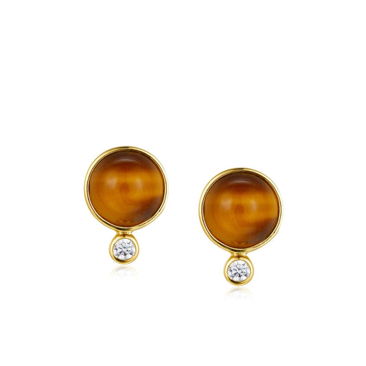 Pair of Awakened Time Ember Gleam round gold stud earrings featuring cabochon natural Tiger's Eye gemstones with small bezel-set cubic zirconia drops on a white background.