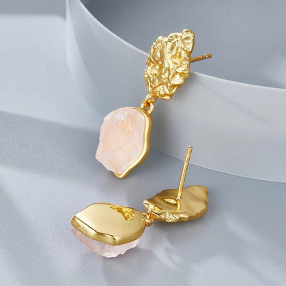 Detailed view of Awakened Time gold vermeil rose quartz earrings showing post backings and smooth back plates.