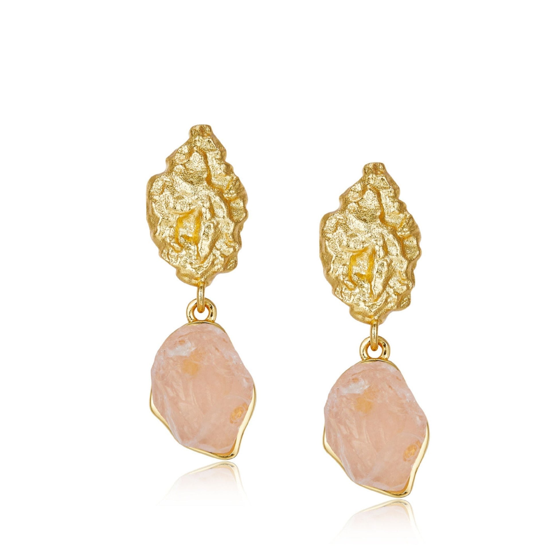 Pair of Awakened Time textured gold stud earrings with raw natural rose quartz gemstone drops on a white background.