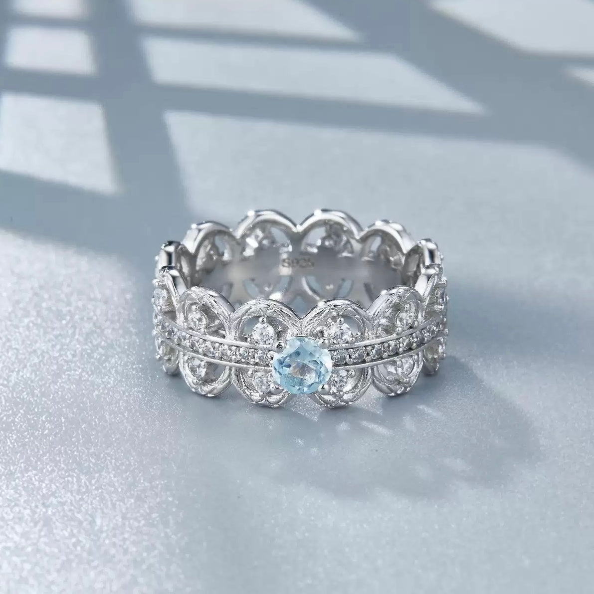Florentine Lace Ring by Awakened Time featuring a luminous natural blue topaz gemstone, intricate lace-inspired silver design, and refined white gold vermeil finish