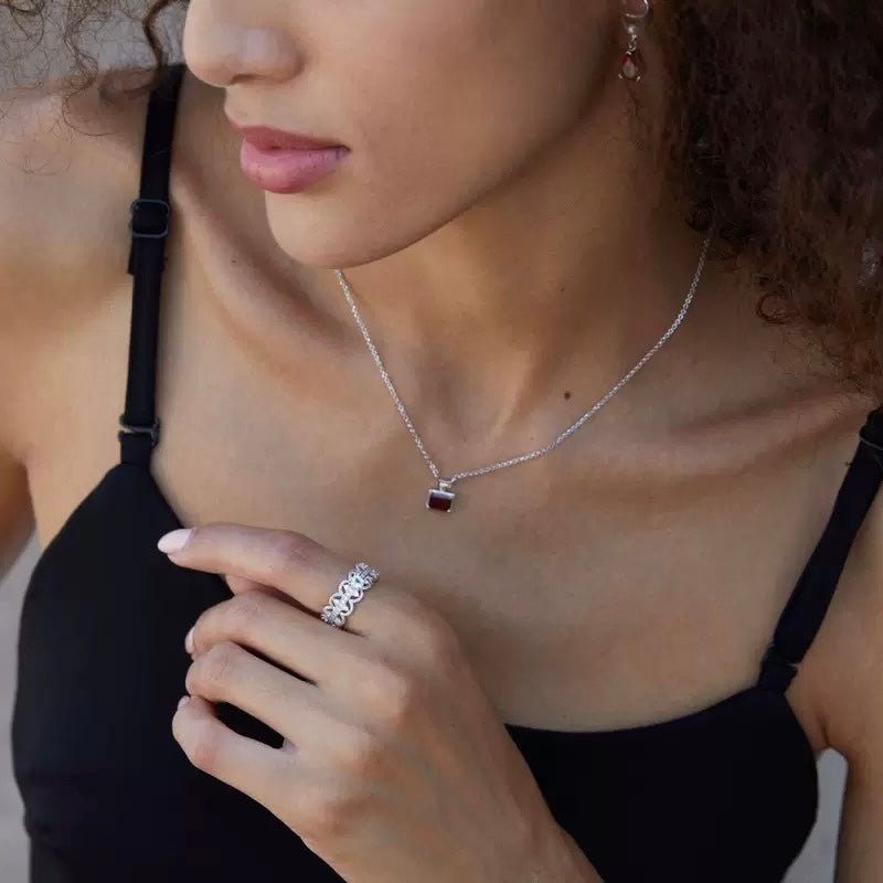 Florentine Lace Ring by Awakened Time worn elegantly on a woman's hand, featuring a luminous natural blue topaz gemstone and intricate lace-inspired white gold vermeil design