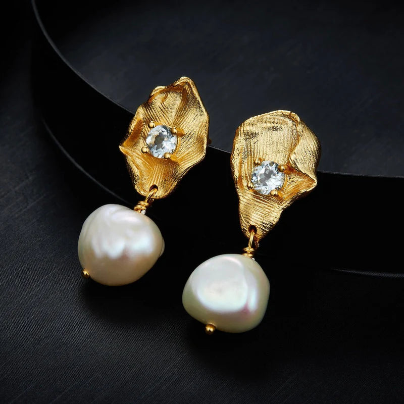 Awakened Time Fleur d'Or earrings featuring elegant floral-inspired gold-tone design