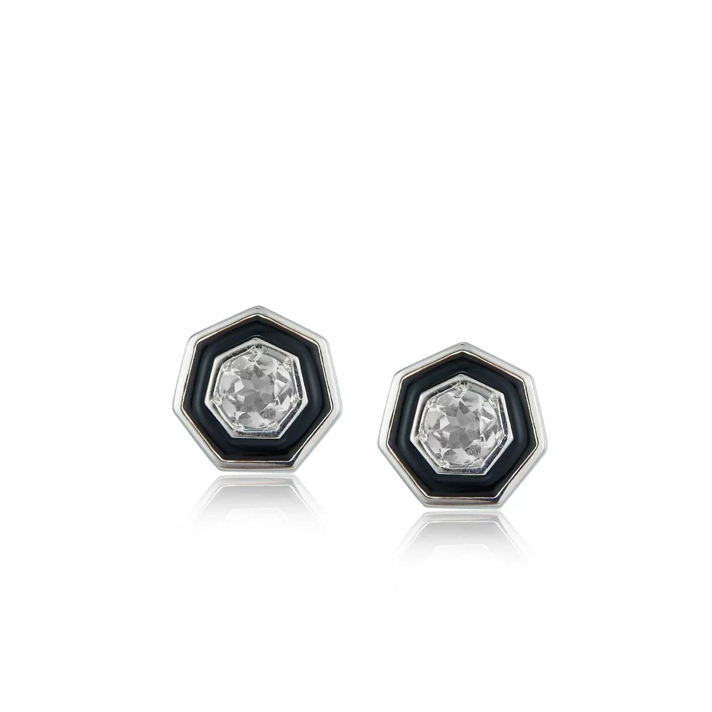 Pair of Awakened Time hexagonal stud earrings featuring clear faceted crystal centers enclosed by black enamel halos and silver borders on a white background.