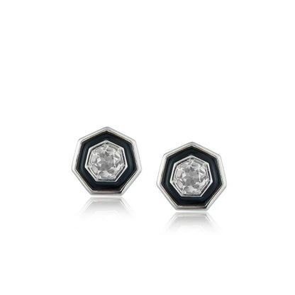 Pair of Awakened Time hexagonal stud earrings featuring clear faceted crystal centers enclosed by black enamel halos and silver borders on a white background.