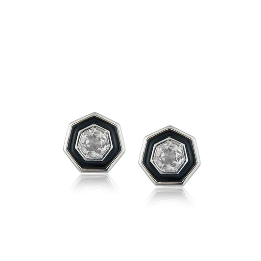 Pair of Awakened Time hexagonal stud earrings featuring clear faceted crystal centers enclosed by black enamel halos and silver borders on a white background.