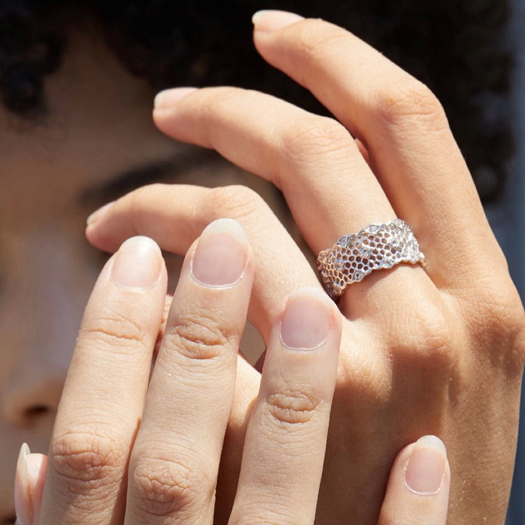 Woman wearing the Awakened Time Iceveil Wide Band Ring featuring a sculptural honeycomb lattice design with a luminous 18ct white gold vermeil finish over 925 sterling silver.