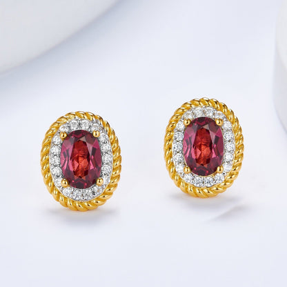 Front view of the pair of Awakened Time Imperial Romance oval Pyrope-Almandine garnet stud earrings with pave diamond halos.