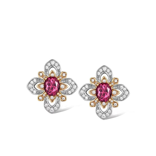 Pair of Awakened Time La Rosa di Firenze two-tone stud earrings featuring oval red garnets encircled by gold petal frames and silver pavé zirconia borders on a white background.