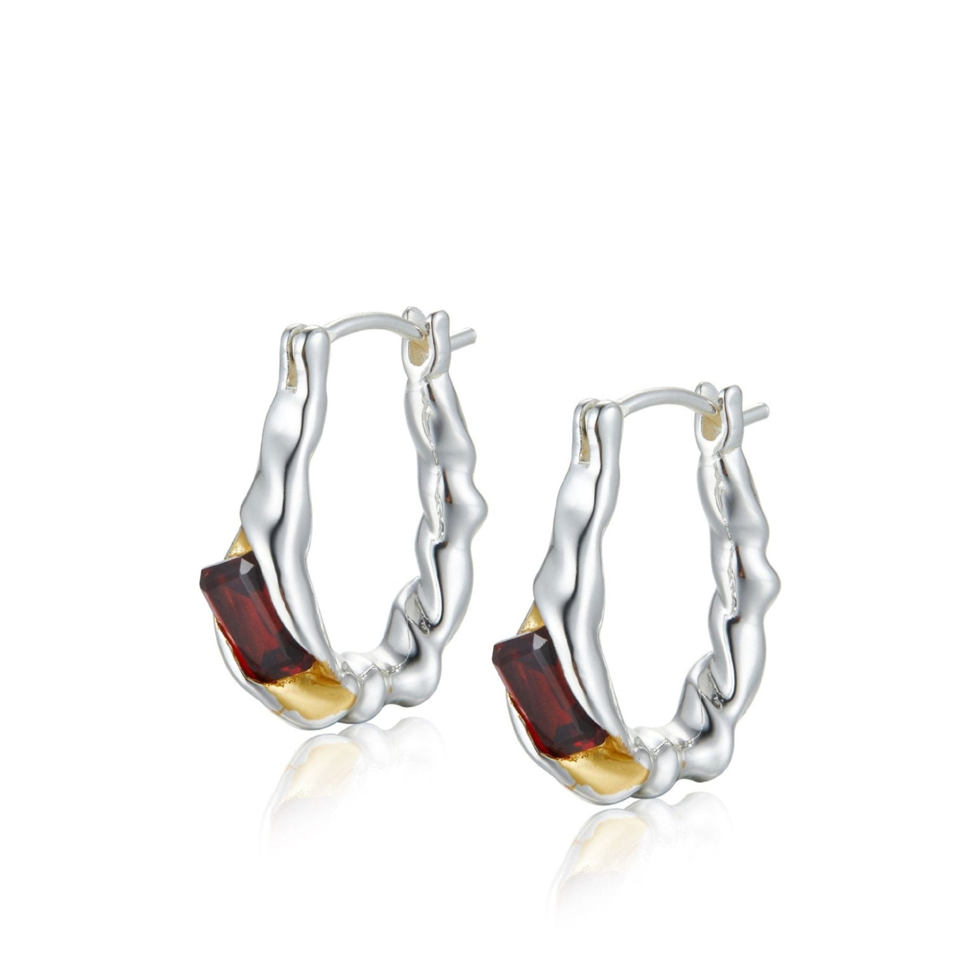 Pair of Awakened Time Lava Ember hoop earrings featuring organic molten silver textures cradling baguette-cut red garnet gemstones with gold accents on a white background.