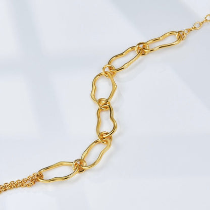 Close-up product shot of the Awakened Time Liaison gold chain bracelet showcasing its unique vintage-inspired links and extender chain on a clean white background.