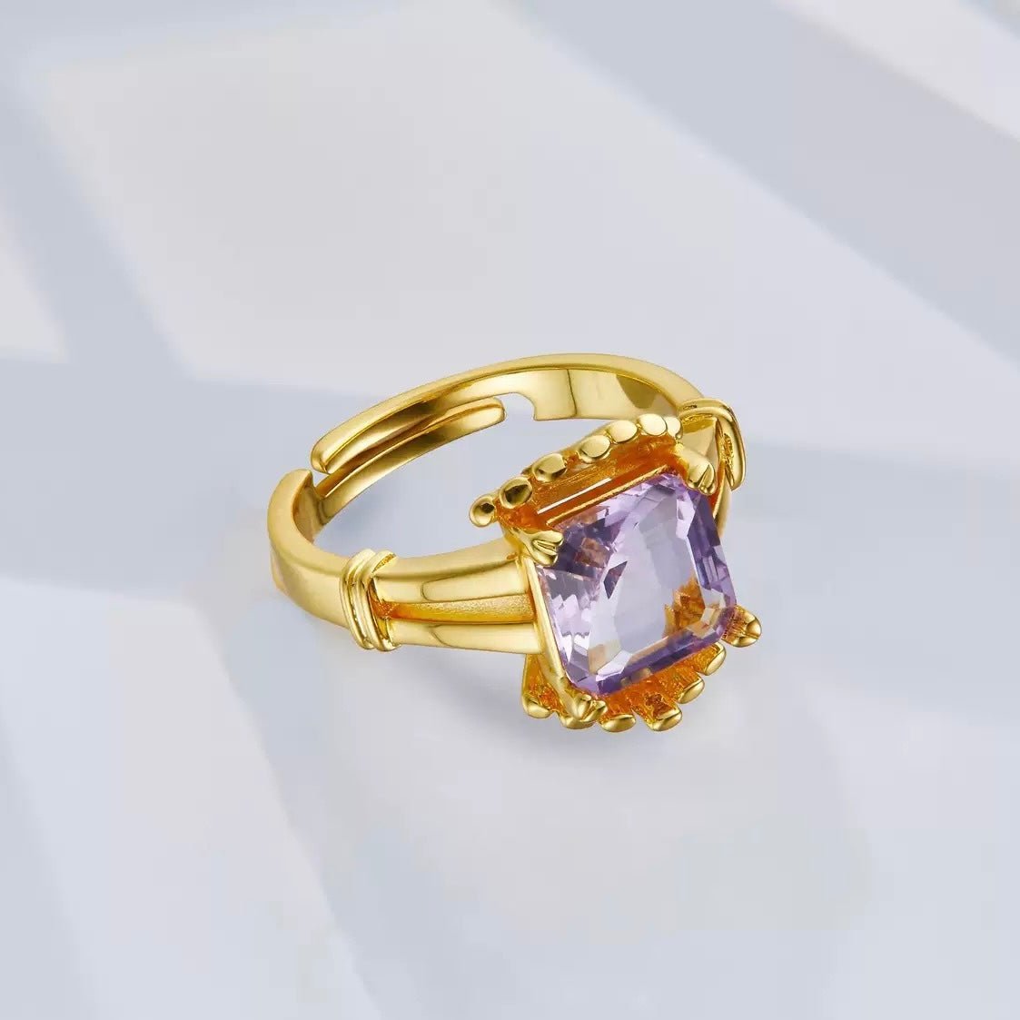 Angled studio view of The Lilac Crown Ring highlighting its adjustable crown-like architecture and gold vermeil finish by Awakened Time.