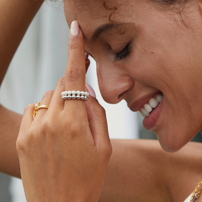 Model showcasing The Lumière white gold pearl ring on her hand, styled by Awakened Time.