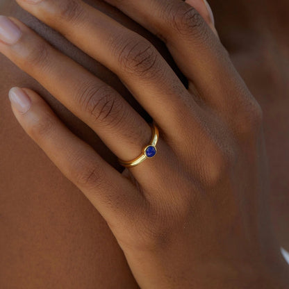 Awakened Time Luna Nova gold ring worn on a hand, featuring a bezel-set gemstone and 14ct recycled gold plated finish.