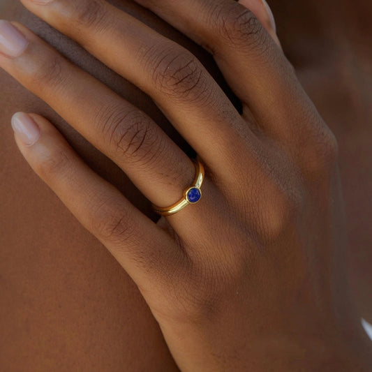 Awakened Time Luna Nova gold ring worn on a hand, featuring a bezel-set gemstone and 14ct recycled gold plated finish.