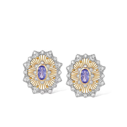 Pair of Awakened Time Medici’s Bloom two-tone stud earrings featuring oval natural tanzanite centers framed by gold sunburst rays and silver pavé zirconia scalloped borders on a white background.