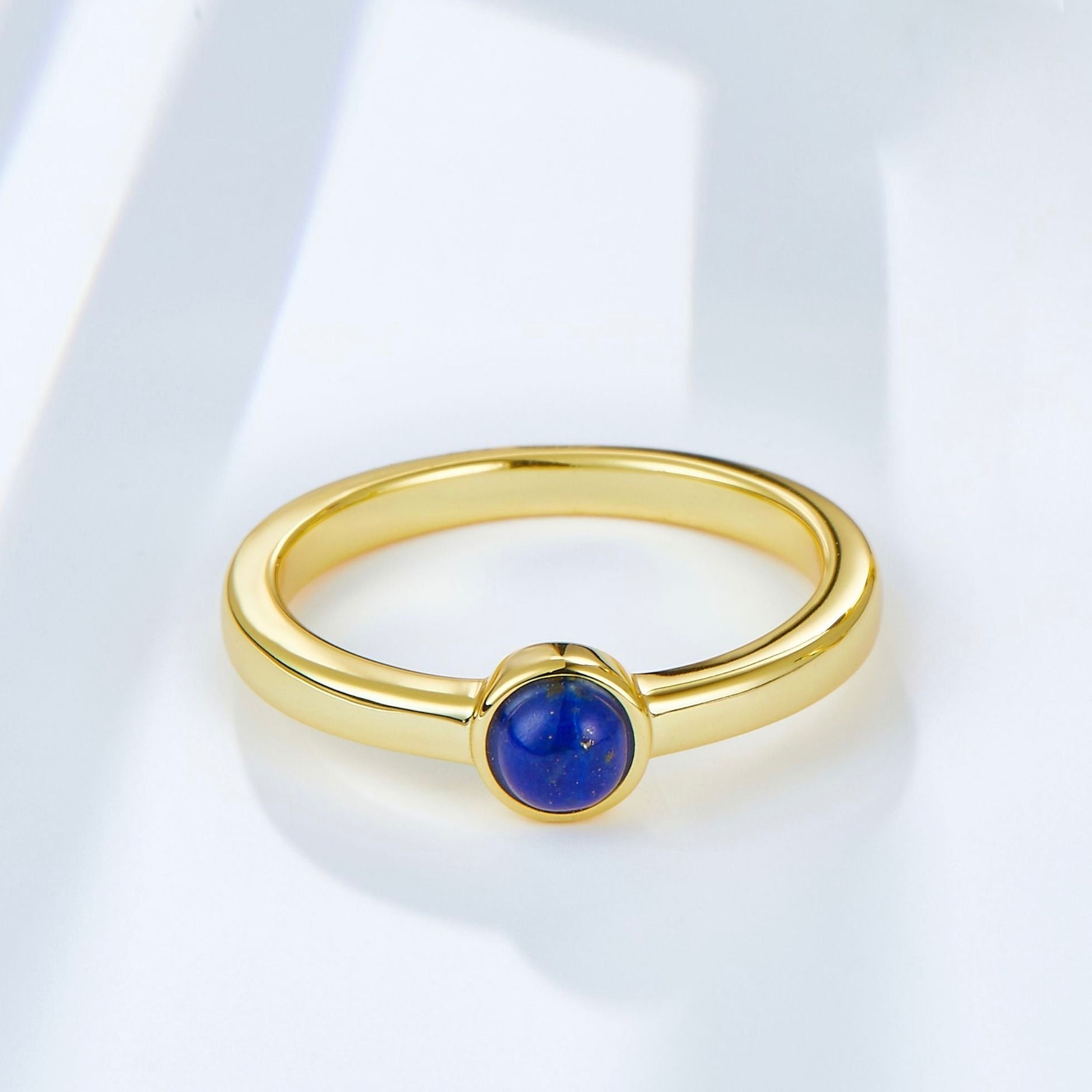 Handcrafted 18ct gold vermeil ring featuring a round, polished lapis lazuli solitaire stone, styled as modern minimalist luxury jewelry by Awakened Time.