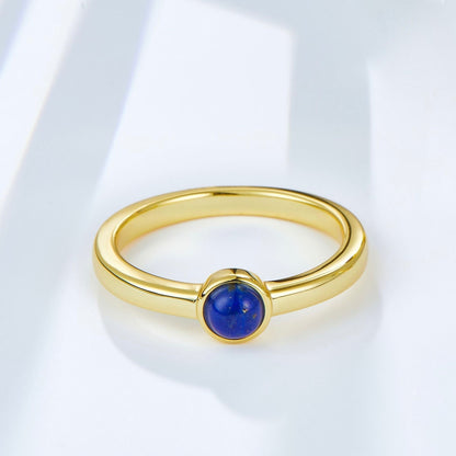 Handcrafted 18ct gold vermeil ring featuring a round, polished lapis lazuli solitaire stone, styled as modern minimalist luxury jewelry by Awakened Time.
