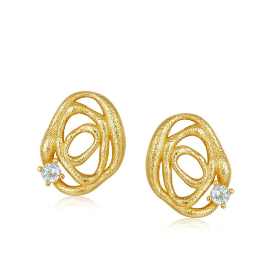 Pair of Awakened Time textured gold openwork wave stud earrings set with natural round blue topaz gemstones on a white background.