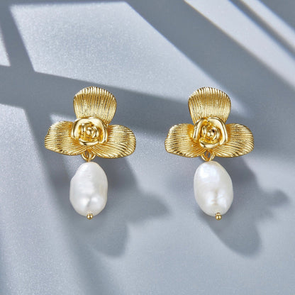 Both Awakened Time gold orchid pearl drop earrings displayed side by side with soft directional shadows.