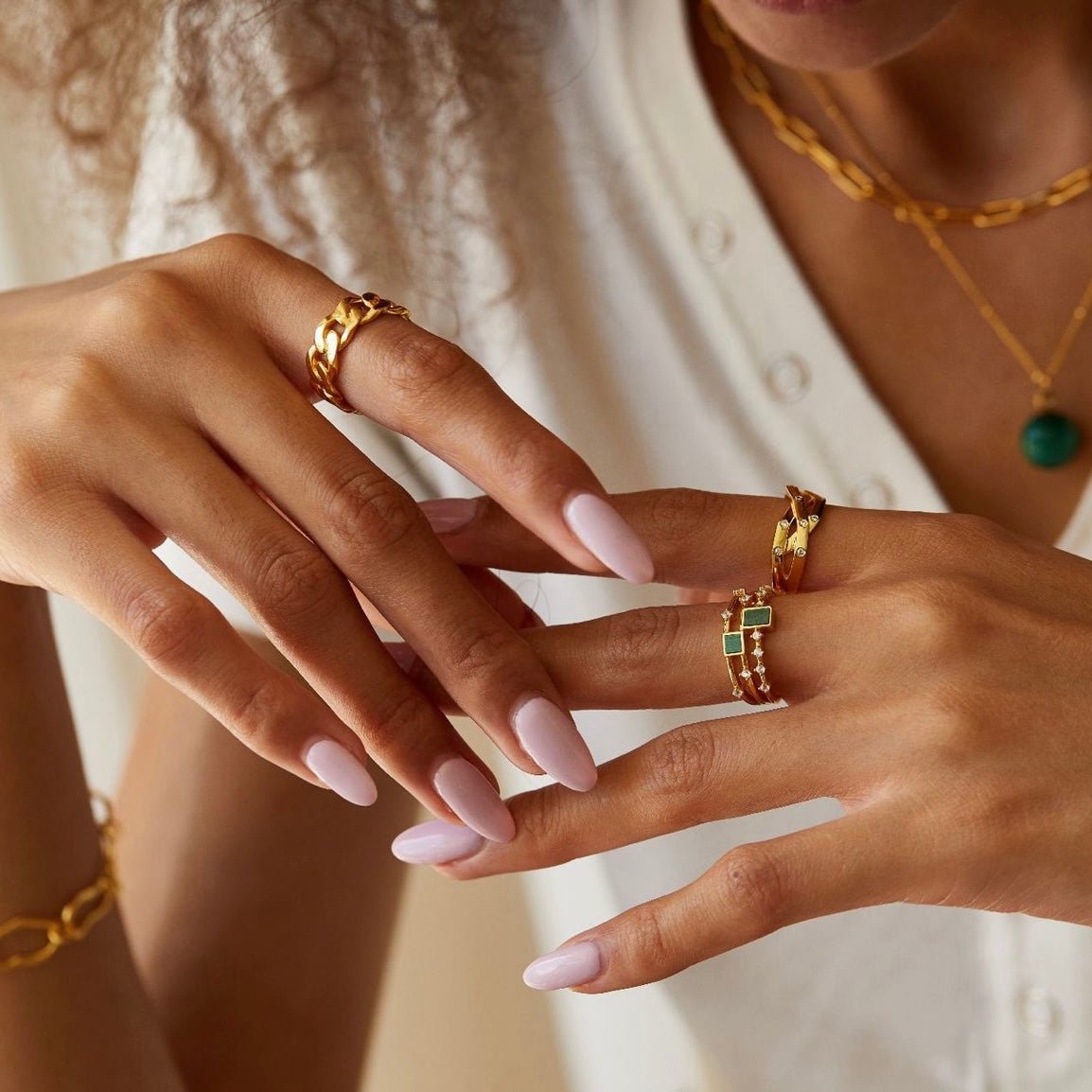 Paris brand Awakened Time luxury gold chain ring styled on a model's hand.