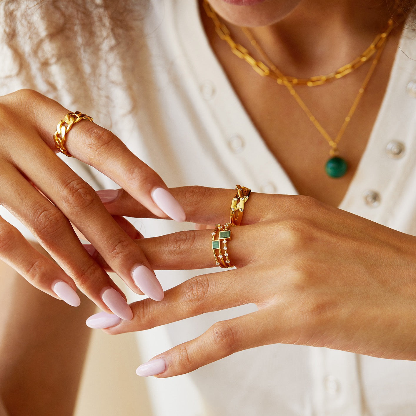 Paris brand Awakened Time malachite gemstone ring styled on a model's hand.