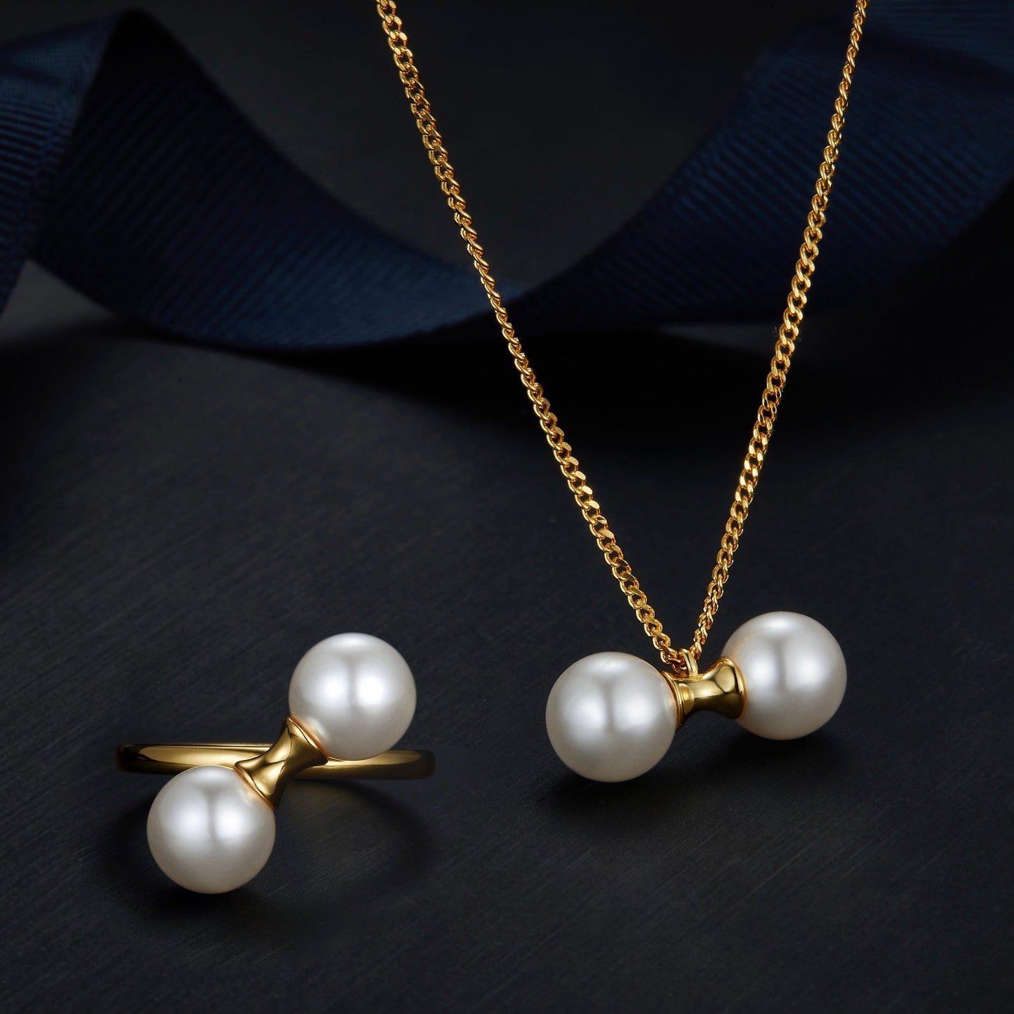 Matching 18ct gold vermeil pearl jewelry set featuring The Petite Symétrie ring and necklace by Awakened Time.