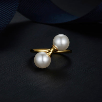 Angled studio view of The Petite Symétrie ring showcasing its balanced dual orbs and 18ct gold vermeil band by Awakened Time.