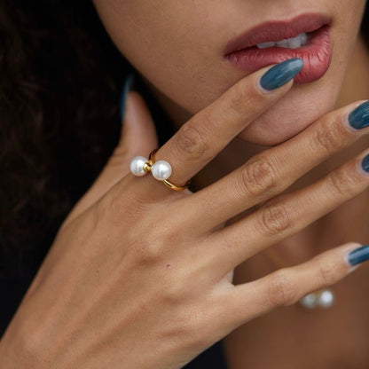 Model showcasing The Petite Symétrie dual-pearl ring with elegant hand gestures, styled by Awakened Time.