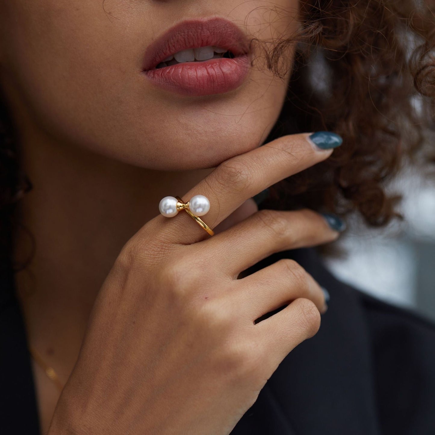 Portrait of a model wearing The Petite Symétrie pearl ring as part of a luxury everyday jewelry collection by Awakened Time.