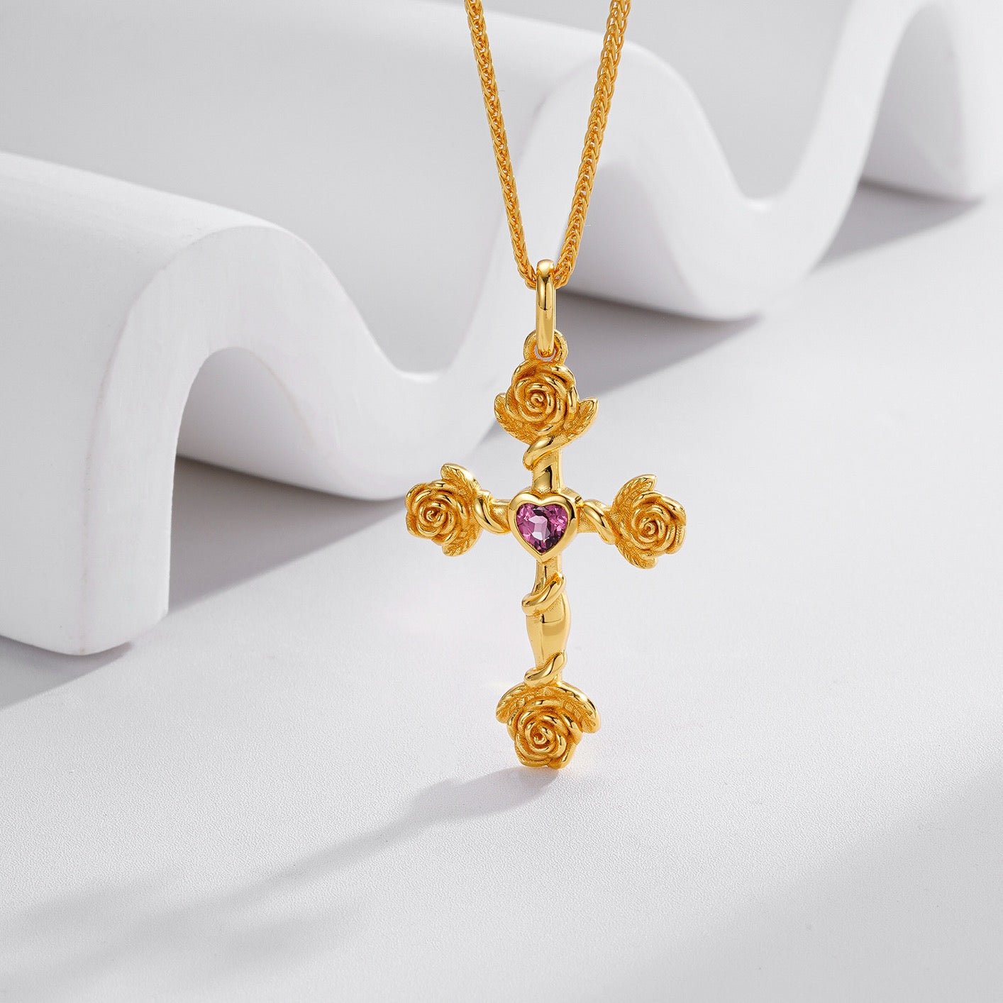 Frontal view of the Awakened Time Rosevine Cross Pendant hanging on a display stand.