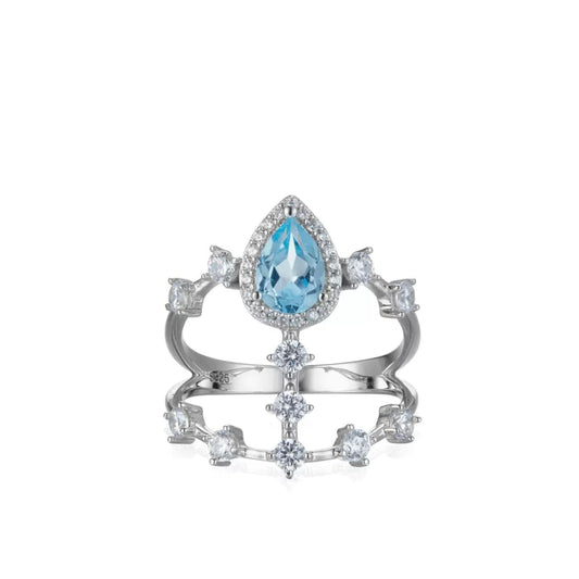 Awakened Time Sky Vault Ring in white gold vermeil featuring a central pear-cut blue topaz surrounded by cubic zirconia in a sculptural openwork setting.