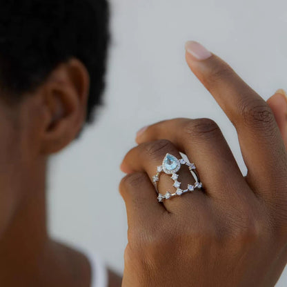 Awakened Time lifestyle view of the Sky Vault Ring worn on a hand, showcasing its statement openwork design, blue topaz, and white gold vermeil finish.