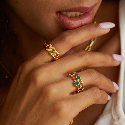 Close-up of stacked gold chain vermeil rings from the Awakened Time high jewelry collection.