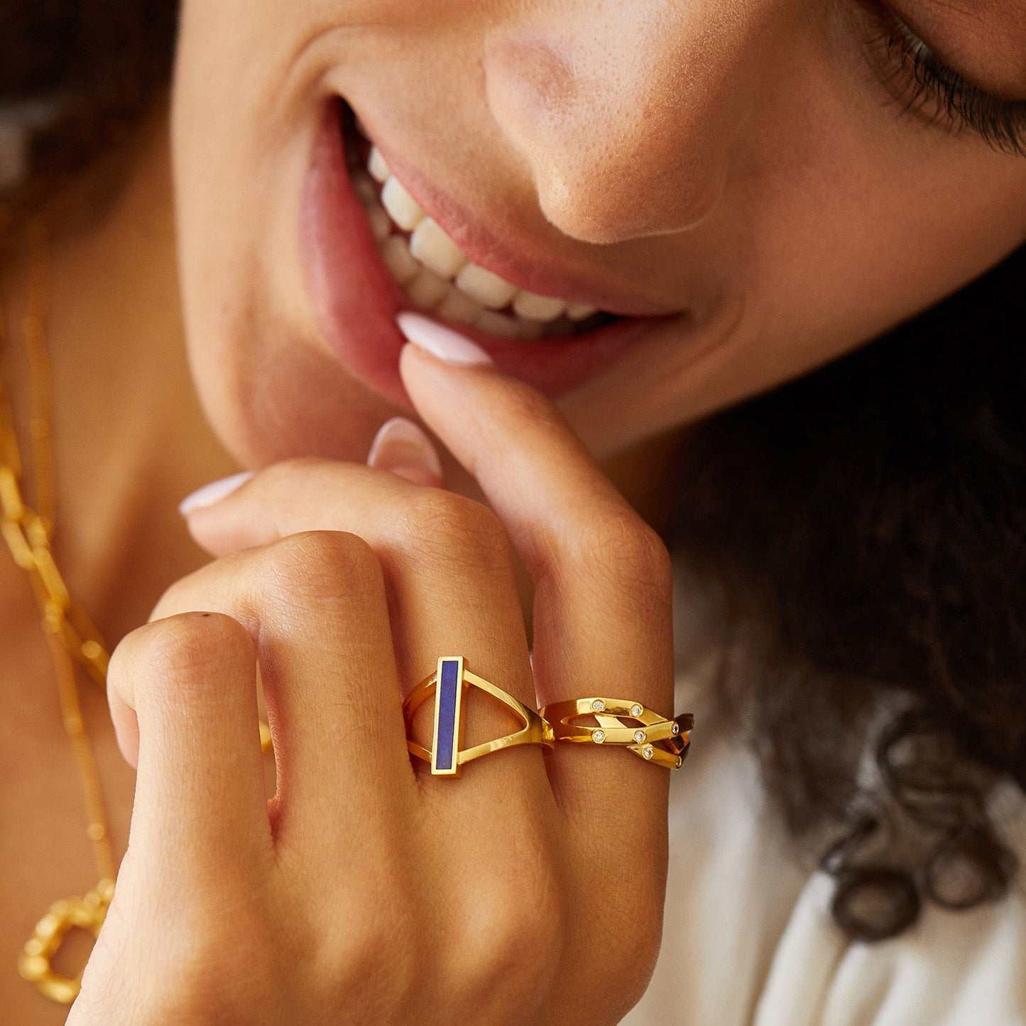Model wearing the Paris-born Awakened Time Trinity Orbit Ring and layered luxury jewelry.