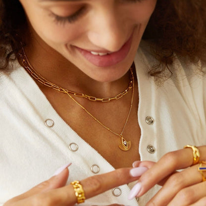 Bare Luxe gold vermeil paperclip necklace worn layered on model