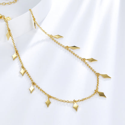 Angled view showing the hanging diamond droplet charms on the Venus Drip gold chain