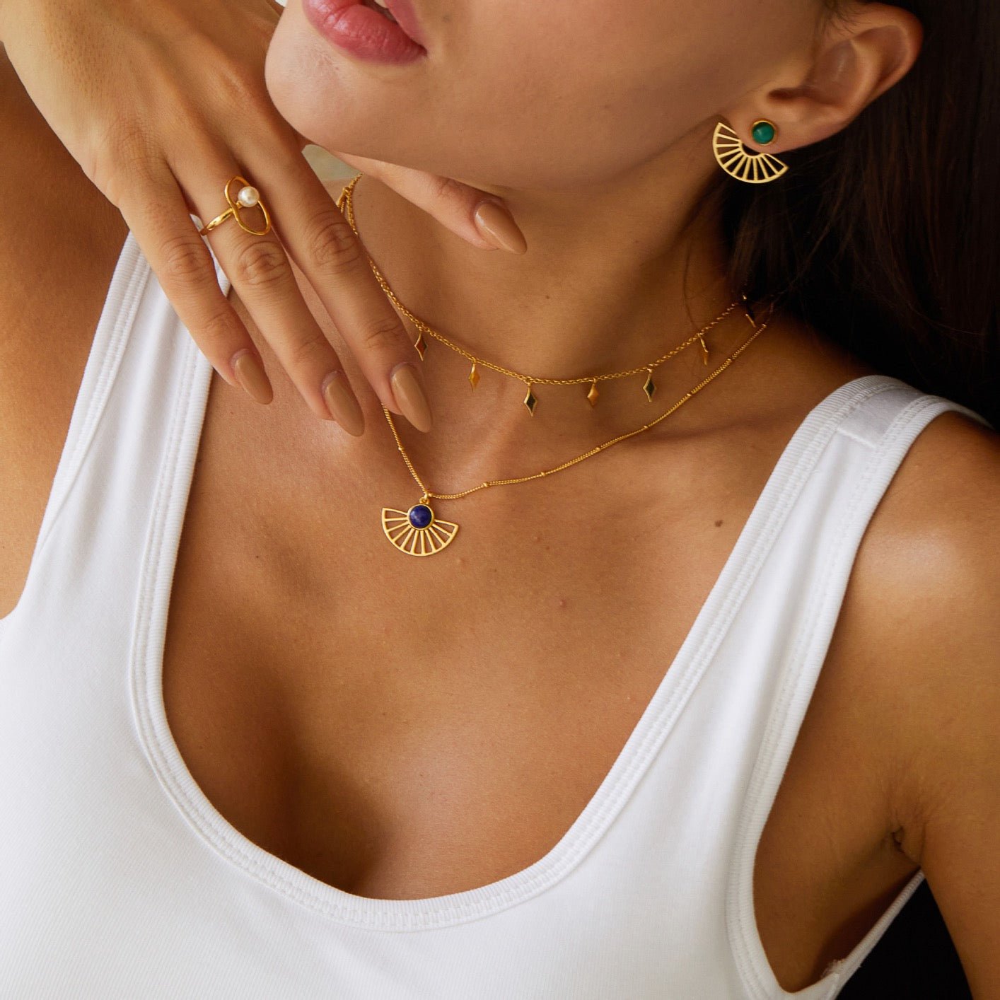 Model wearing the Bare Luxe Venus Drip necklace paired with a fan charm pendant